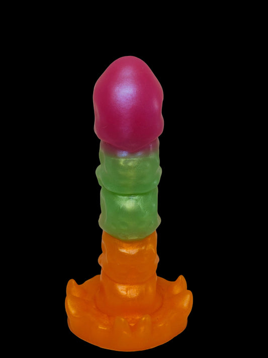 Colorful plastic toy with pink top, green middle, and orange bottom on a light background