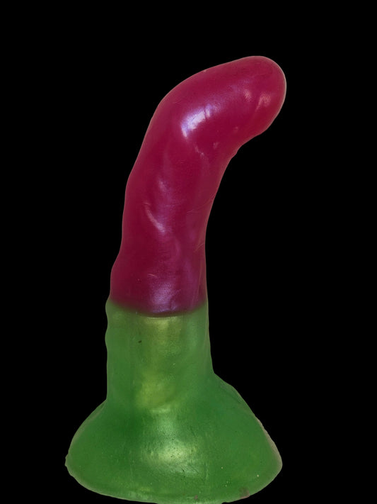 Colorful plastic toy with a pink and green design on a beige background